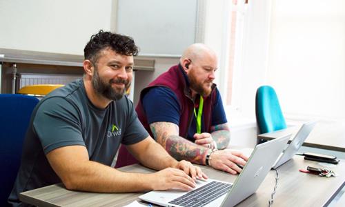 Image Of Two Orwell Colleagues Using Their Laptops Image Of Two Orwell Colleagues Using Their Laptops