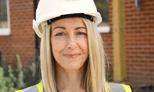 Image of a female with blonde hair wearing a hard hat and looking at the camera. Image of a female with blonde hair wearing a hard hat and looking at the camera.